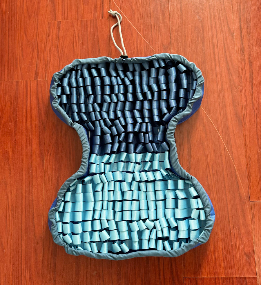 PuzzlePup SmartMat with navy and aqua fabric folds and its full outline visible