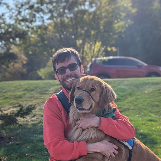 PuzzlePup founder Mike with his service dog Normie