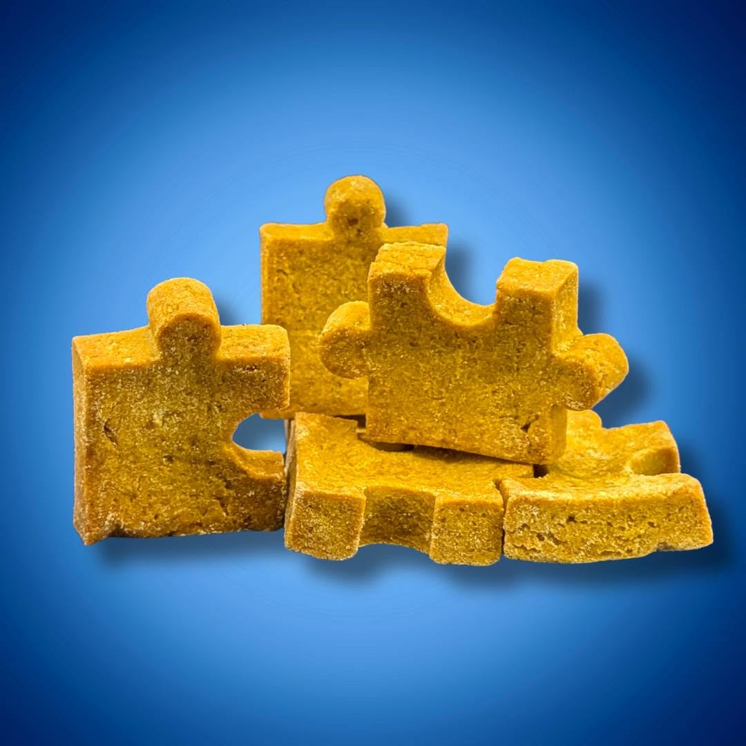 Close view from the supplied product photograph of thick golden PuzzlePup puzzle-piece cookies.