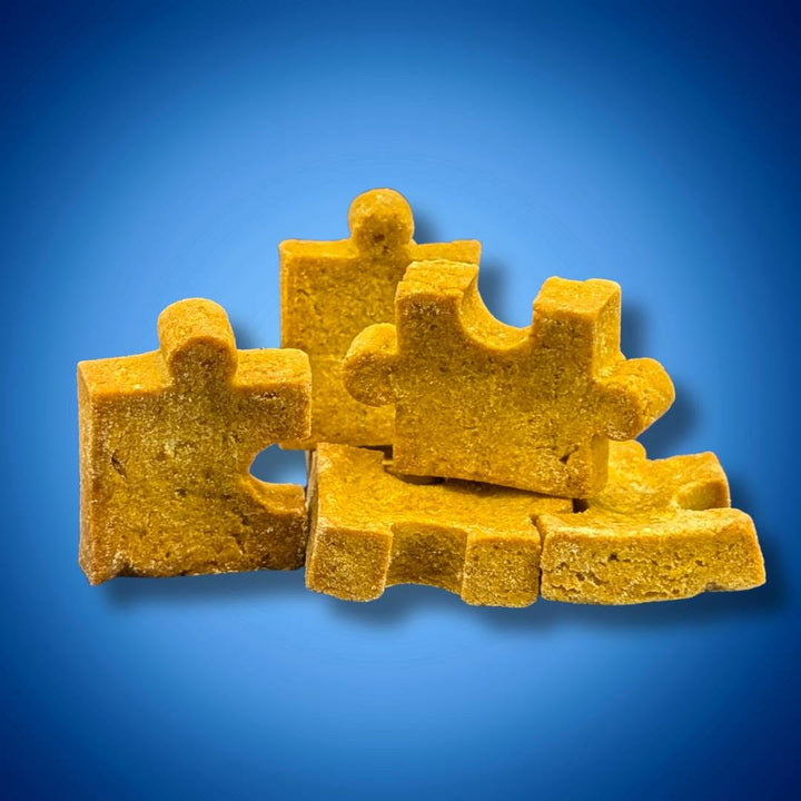 Close view from the supplied product photograph of thick golden PuzzlePup puzzle-piece cookies.